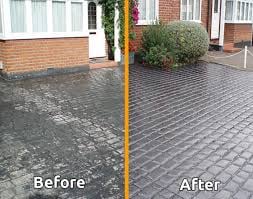 Before and after comparison of driveway cleaning, showing dirty moss-covered surface transforming to clean paved surface